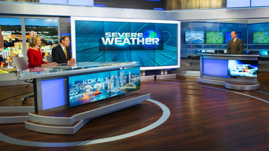 View of anchor desk, video wall and weather center.